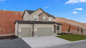 View of front facade featuring a front lawn and a garage