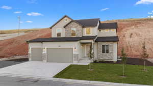 View of front of property with a front yard and a garage