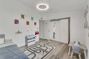 Bedroom featuring light hardwood / wood-style flooring and lofted ceiling