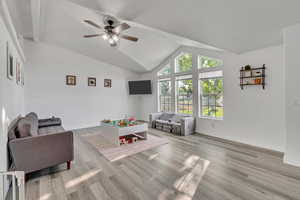 Game room with ceiling fan, lofted ceiling, and light hardwood / wood-style floors