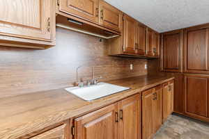 Kitchen with sink and a textured ceiling