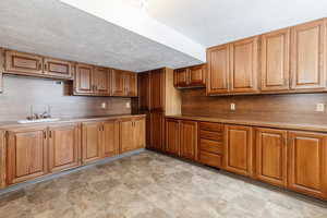 Kitchen featuring sink and a textured ceiling