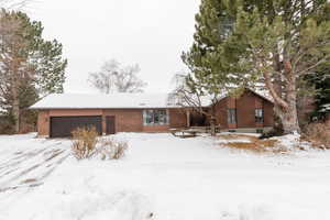 Ranch-style house featuring a garage