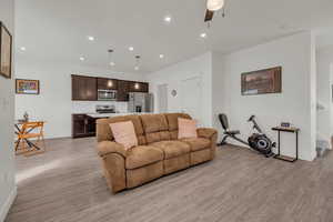 Living room featuring ceiling fan and light wood-type flooring