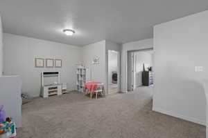 Playroom/Den/Loft/ Game Room. Entrance to laundry and Primary Bedroom