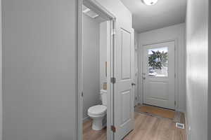 Bathroom and front door, hardwood / wood-style floors