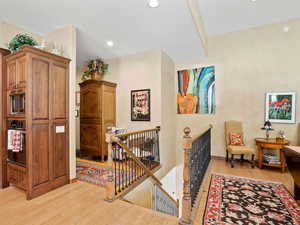 Hall with light hardwood / wood-style floors