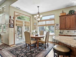 Dining space with a chandelier and light hardwood / wood-style floors