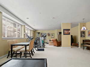 Workout room with light colored carpet