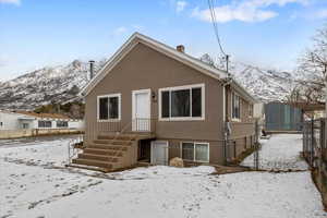 Snow covered house featuring a mountain view