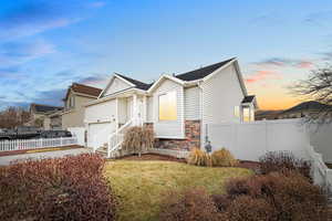 View of front of home featuring a yard and a garage