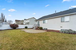 Rear view of house with a patio and a yard