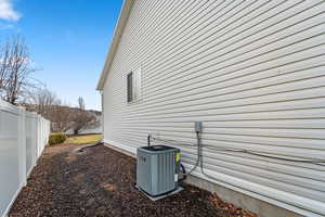 View of side of home with central AC unit