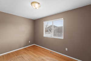 Empty room featuring hardwood / wood-style flooring