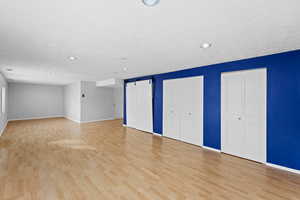 Interior space with a barn door and light wood-type flooring