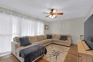 Living room featuring hardwood / wood-style flooring and ceiling fan