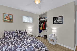 Bedroom featuring a closet, ceiling fan, and light hardwood / wood-style flooring