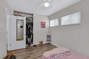 Bedroom featuring a closet, hardwood / wood-style flooring, and ceiling fan