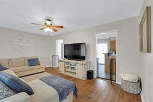 Living room featuring light wood-type flooring and ceiling fan