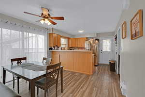 Dining space featuring ceiling fan and light wood-type flooring