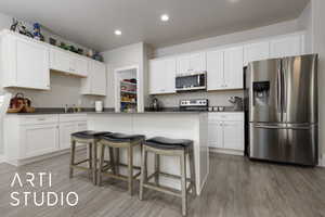 Kitchen with appliances with stainless steel finishes, white cabinets