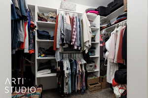 Walk in closet featuring carpet flooring