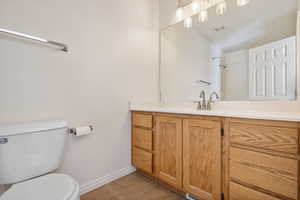 Bathroom with tile patterned flooring, vanity, and toilet