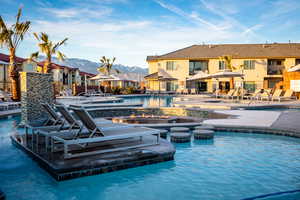 View of pool featuring a mountain view, a patio, and a jacuzzi