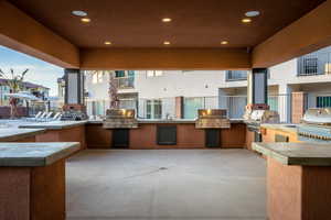 View of patio featuring exterior kitchen and a grill