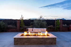 Patio terrace at dusk with a mountain view and a fire pit