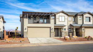 Multi unit property with cooling unit, a garage, a balcony, and a mountain view