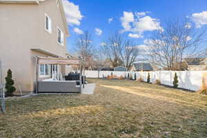 View of yard with an outdoor living space and a pergola