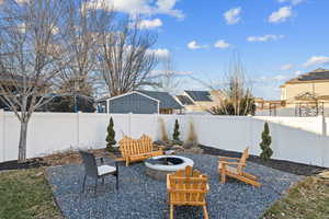 View of patio with an outdoor fire pit