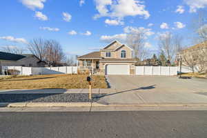 View of front property with a porch and a garage