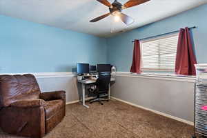 Office featuring carpet, ceiling fan, and a textured ceiling