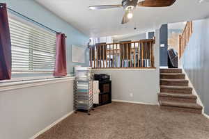 Interior space with ceiling fan and carpet