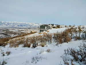 Snowy yard with a mountain view