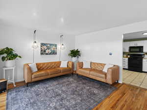 Living room with light hardwood / wood-style flooring