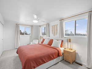 Bedroom featuring light colored carpet and ceiling fan