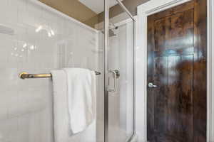 Bathroom featuring a shower with door