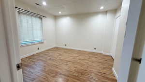 Empty room featuring light hardwood / wood-style floors and a textured ceiling