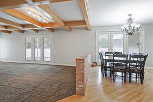 Dining room featuring french doors, beamed ceiling, and plenty of natural light