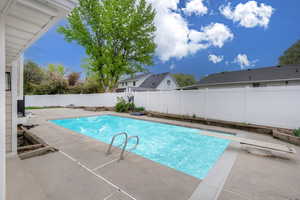 View of swimming pool with a diving board