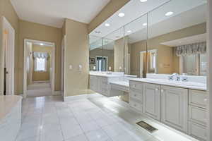 Bathroom with tile patterned floors and vanity