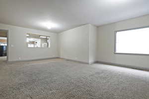 Carpeted spare room featuring washer / clothes dryer