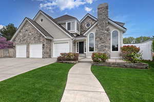 View of front of home featuring a front lawn and a garage