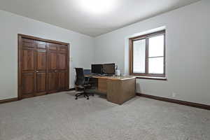 Office area featuring light carpet