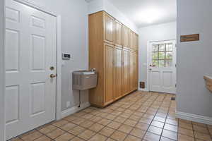 Entryway with light tile patterned flooring