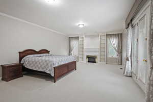 Bedroom with light carpet and crown molding