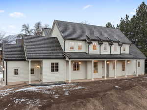 Snow covered house featuring a patio area